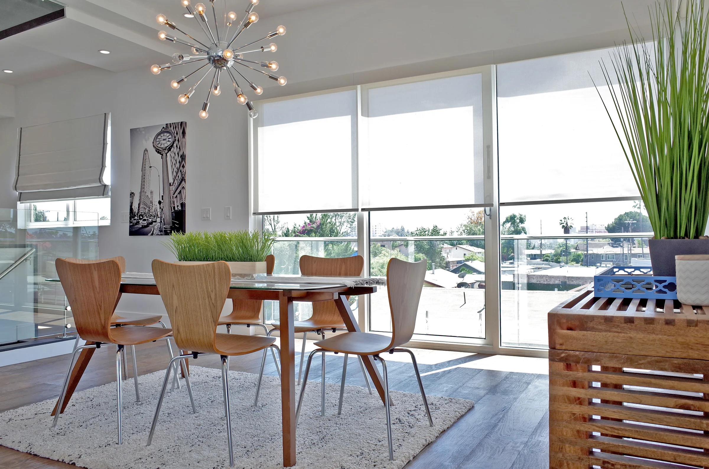Bright dining room with custom shades across large windows