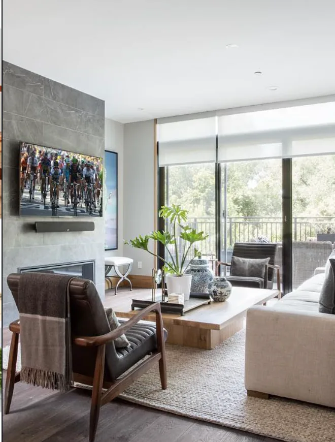 Light-filtering roller shades installed across a bright living-room window